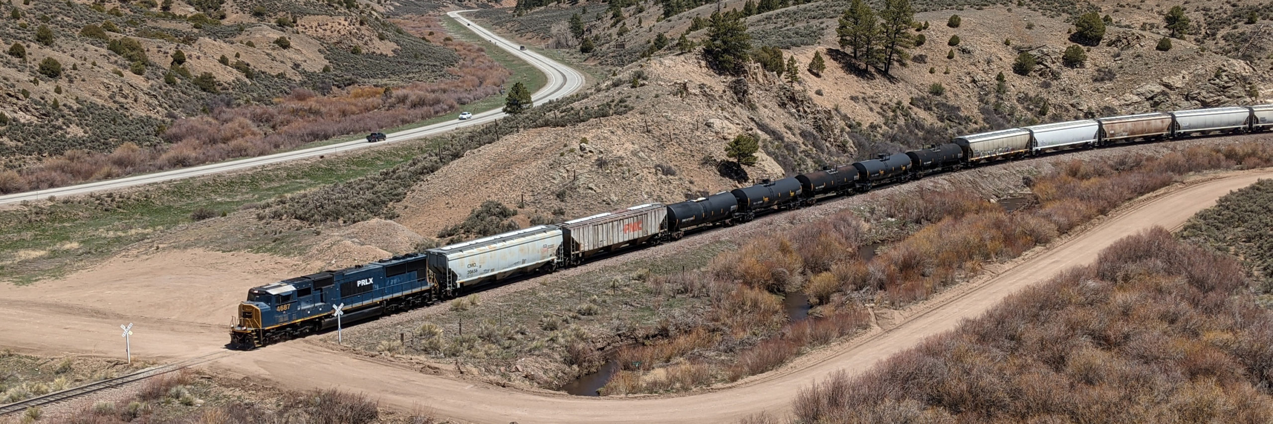 train with long line of freight cars travels on tracks over La Veta Pass