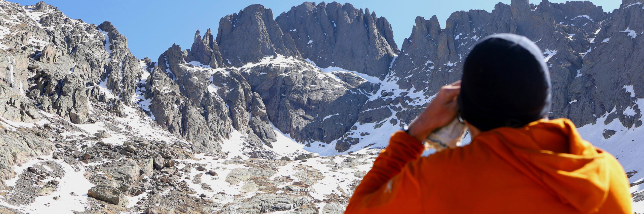 climber facing a frozen rocky mountainside